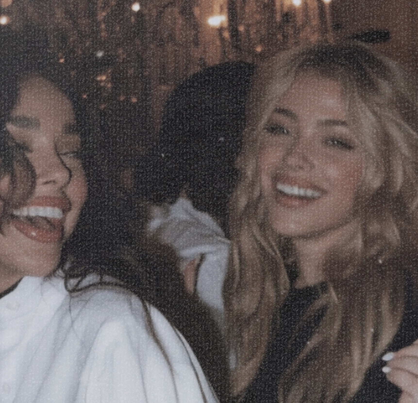 Two friends laughing together after dark